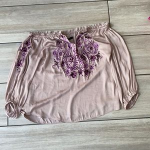 Rose gold colored shirt with purple flower design
